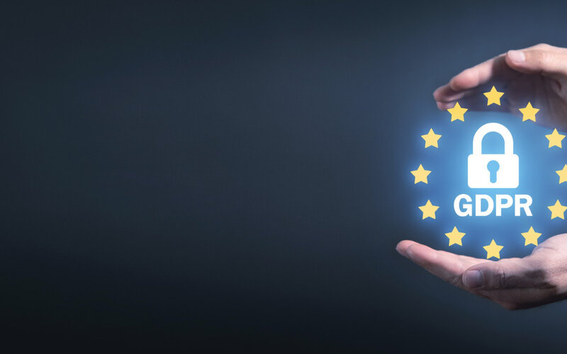 Hands holding GDPR hologram representing data protection compliance