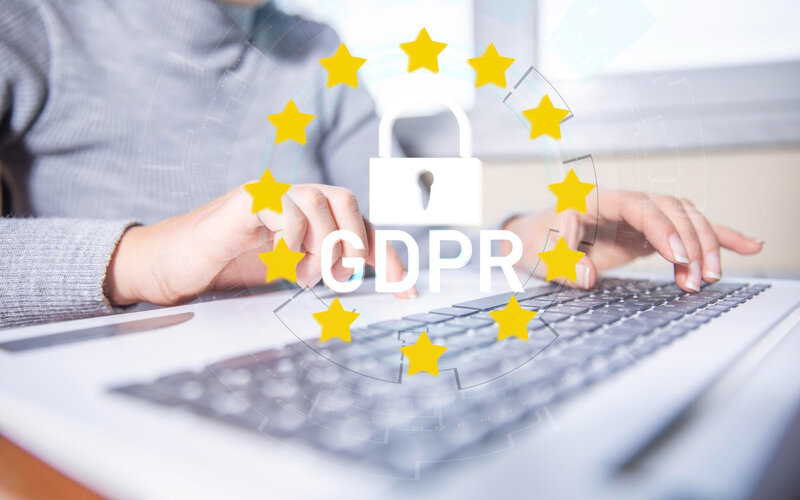 Woman typing on laptop with GDPR lock and EU stars overlay